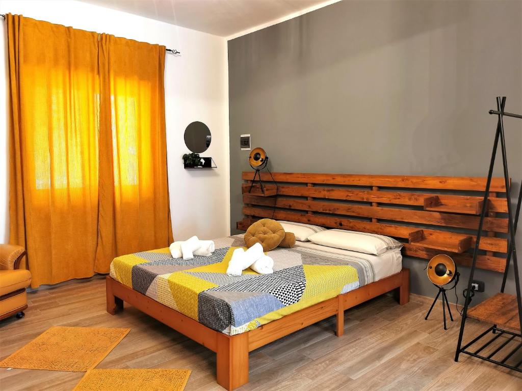 a bedroom with a bed with a teddy bear on it at EverGreen House in Agrigento