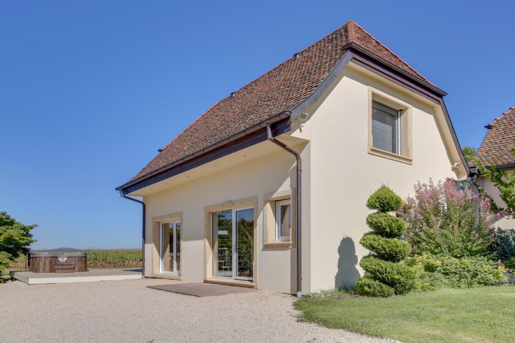 a small white house with a roof at L'Atelier 4 stars Luxury, Hot Tub, Pool in Nambsheim