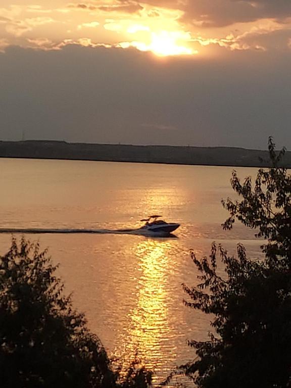 a boat on the water at sunset at Mona in Mamaia