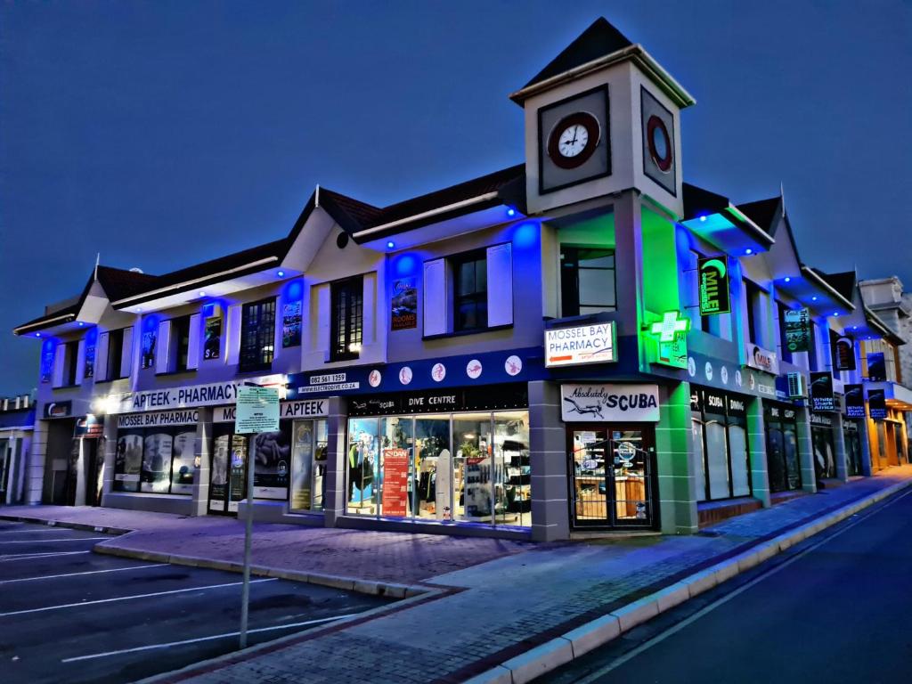 un edificio con una torre de reloj en una calle en Mile Crunchers Backpackers & Hostelling, en Mossel Bay