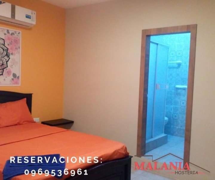 Postel nebo postele na pokoji v ubytování Hostal Malania