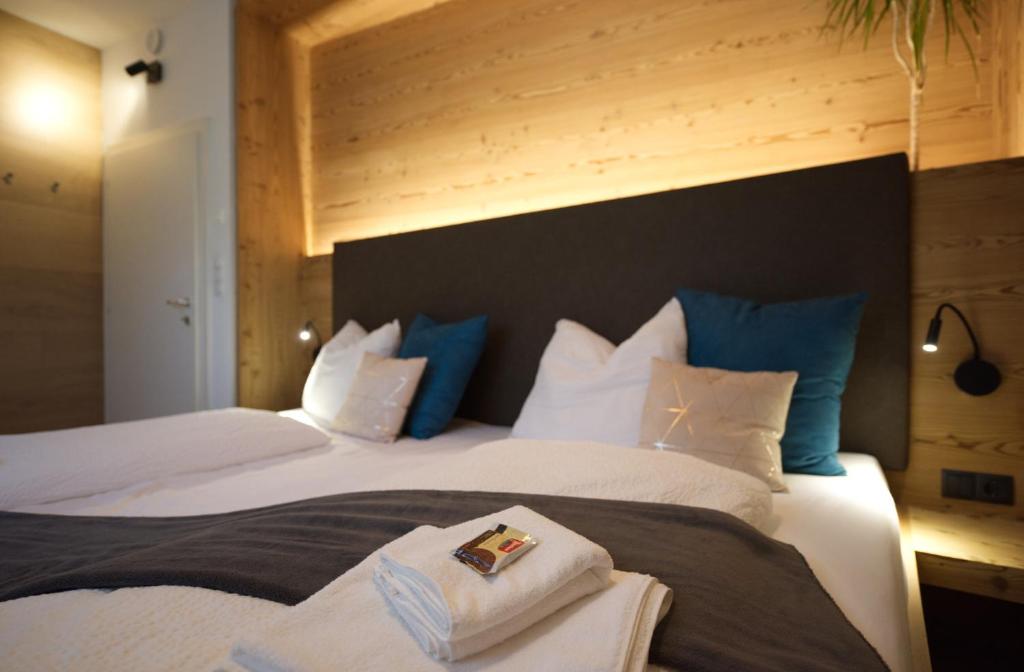a bedroom with two beds with blue and white pillows at CityChalet family Bozen in Bolzano