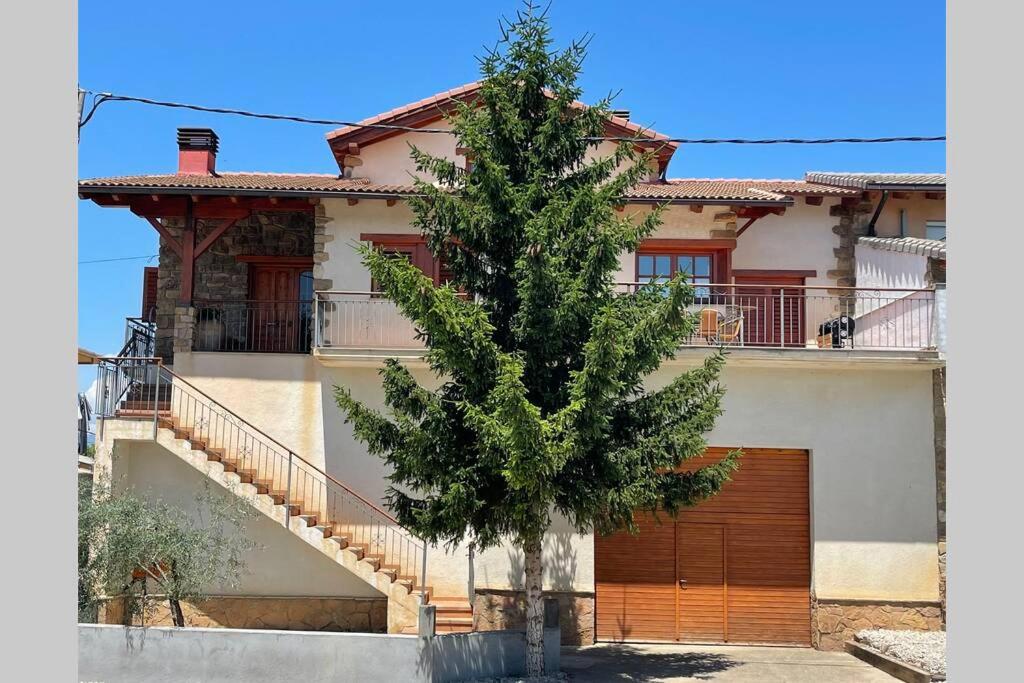a house with a tree in front of it at Ca l’Albert - Casa rural acollidora in Isona