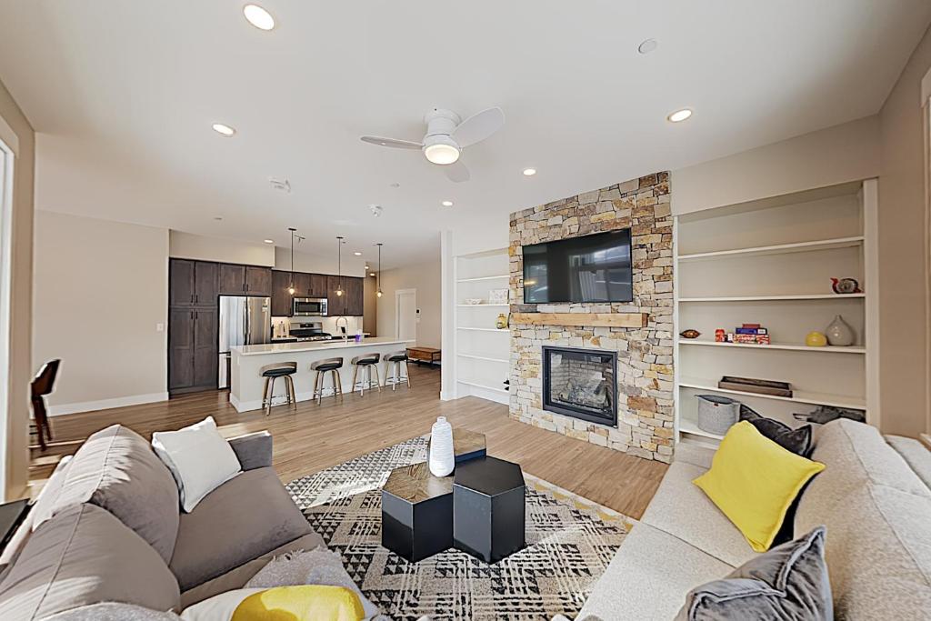 a living room with a couch and a fireplace at New Luxury Loft #307 With Huge Hot Tub & Great Views - 500 Dollars Of FREE Activities & Equipment Rentals Daily in Winter Park