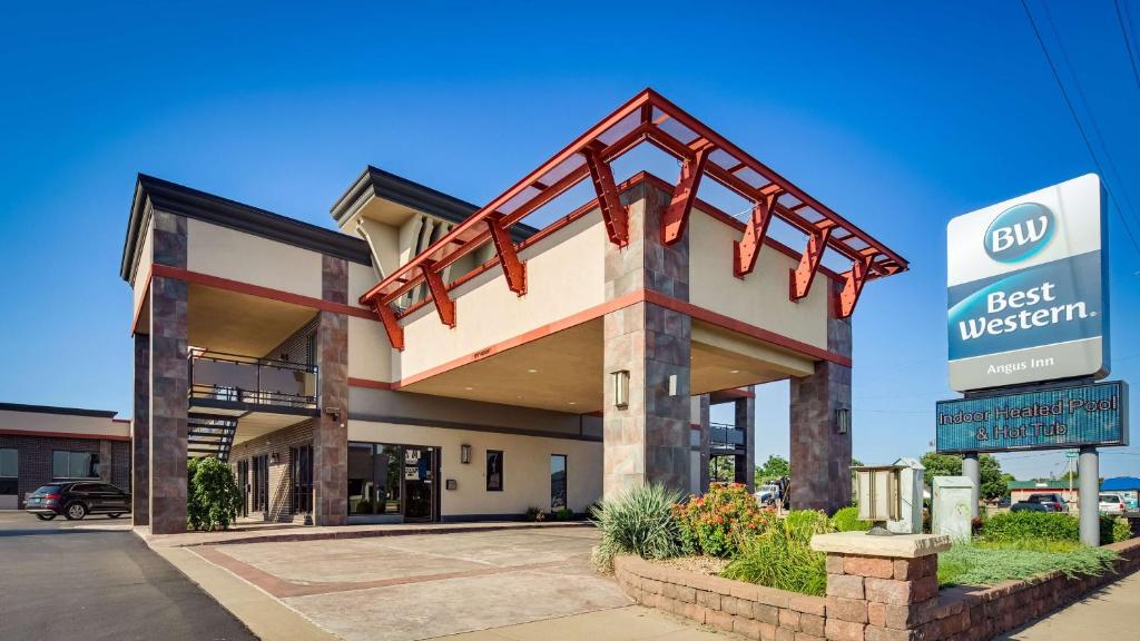 a best western building with a sign in front of it at Best Western Angus Inn in Great Bend