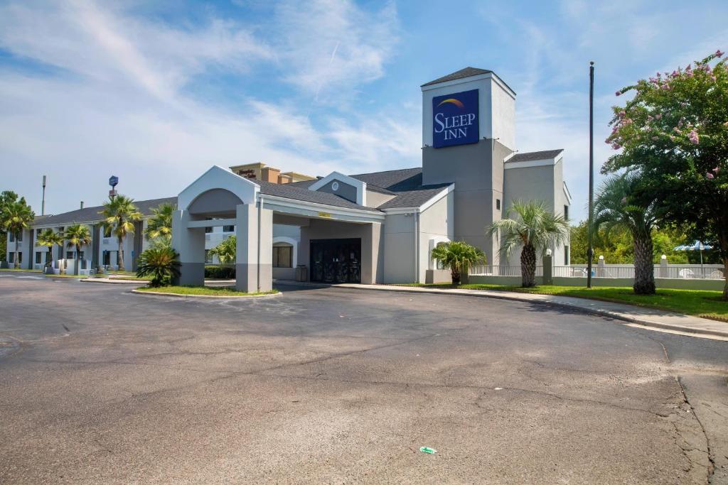 a building with a sign on the side of a street at Sleep Inn Savannah Gateway I-95 in Savannah