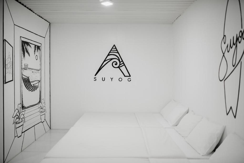a room with a drawing on the wall at Suyog Life Siargao in General Luna