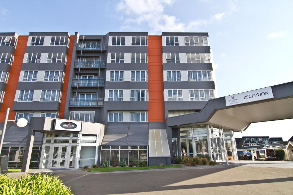 a large building with a parking lot in front of it at Copthorne Hotel Palmerston North in Palmerston North