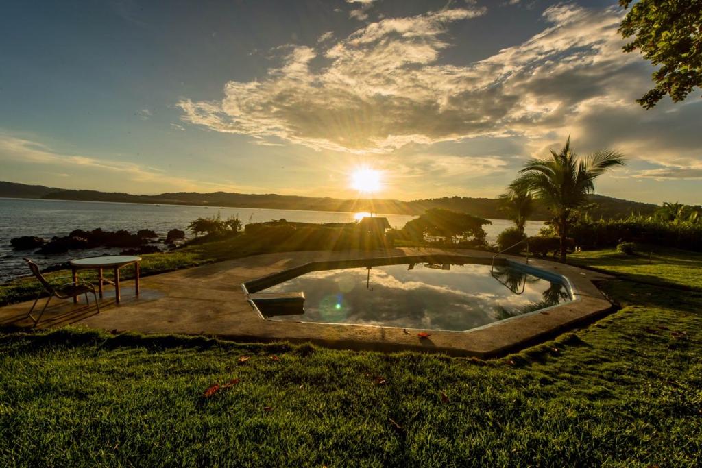 a hot tub in the grass next to a body of water at Drake Paradise Point in Drake
