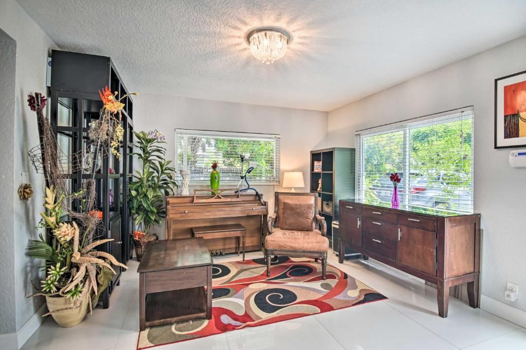 a living room with a piano and a chair at Shady and Eclectic Fort Lauderdale Dwelling with Yard! in Fort Lauderdale