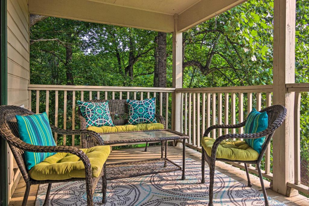 a porch with two chairs and a table and a bench at Modern Studio with Balcony about 1 Mi to Lake Lure! in Lake Lure