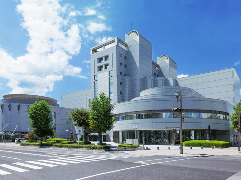 a large building with a street in front of it at Hiroshima International Youth House JMS Aster Plaza in Hiroshima