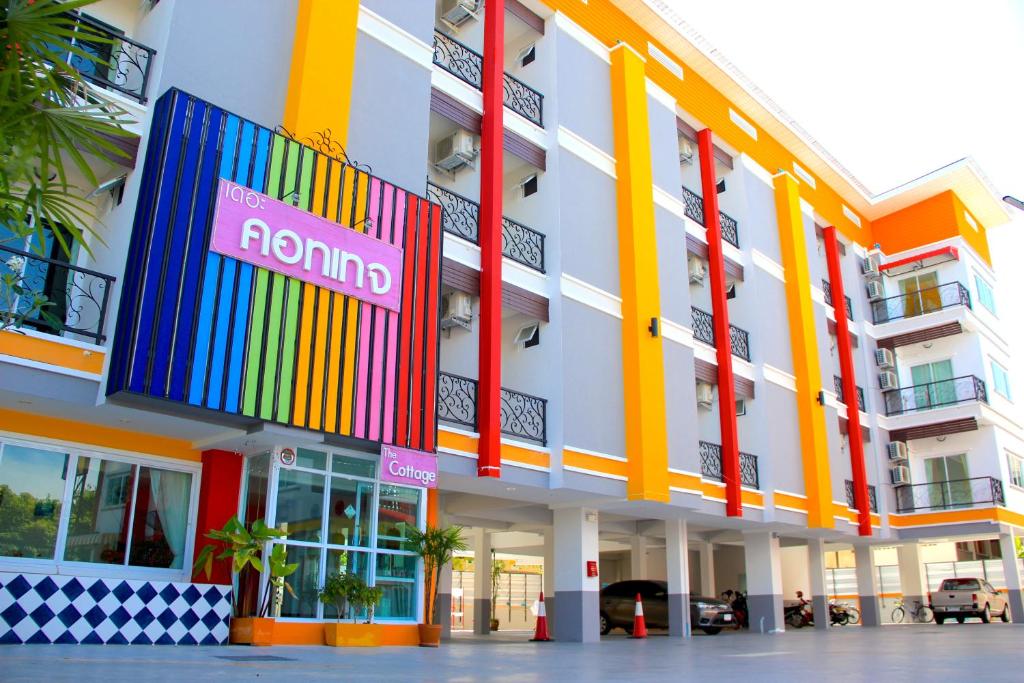 a colorful building with a rainbow sign on it at The Cottage Lampang in Lampang