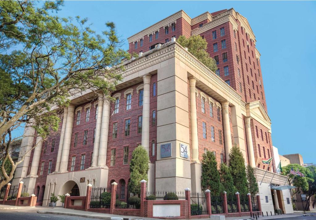 a large brick building with a tall building at 54 on Bath in Johannesburg