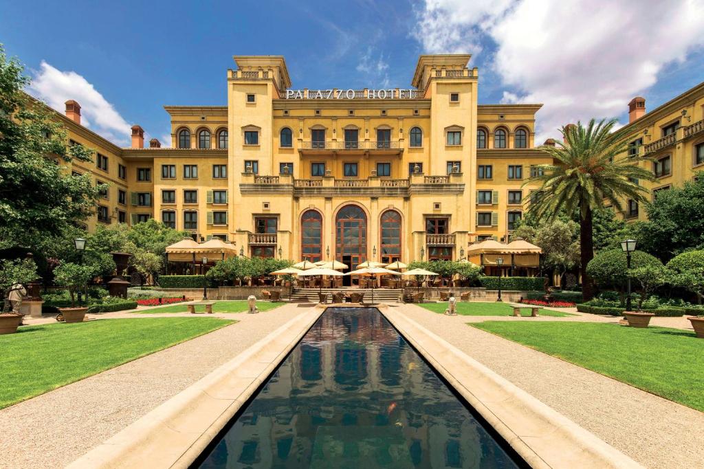a large building with a fountain in front of it at Palazzo Hotel in Johannesburg