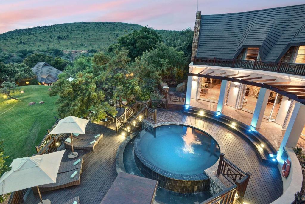 an aerial view of a house with a swimming pool at Mount Grace Hotel & Spa in Magaliesburg