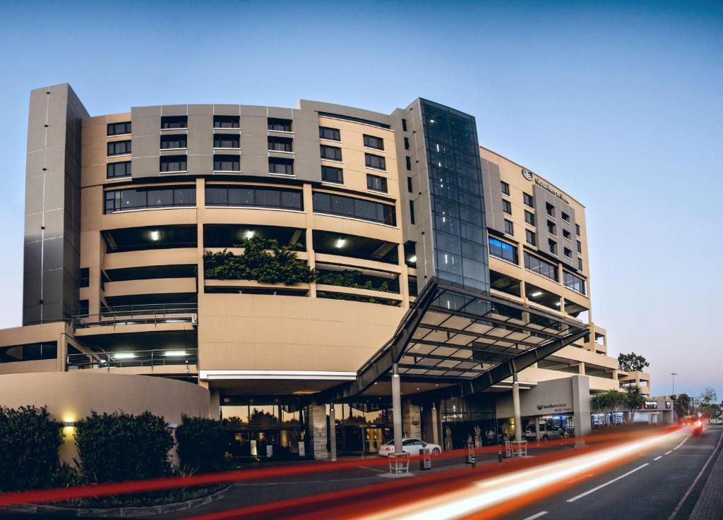 a large building with a street in front of it at Southern Sun Hyde Park Sandton in Johannesburg