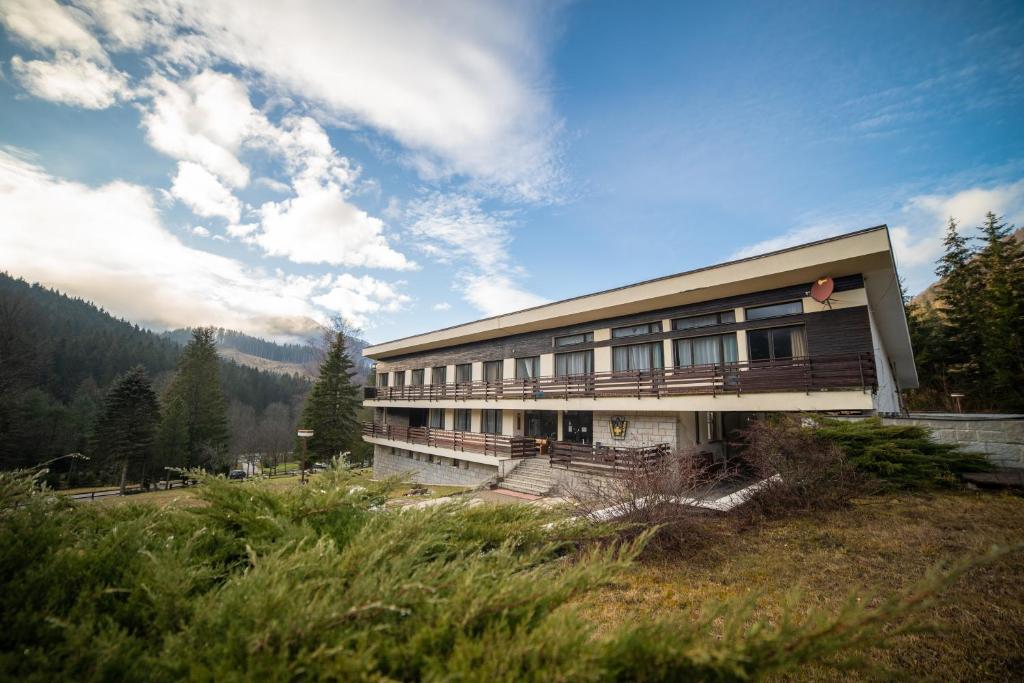 a large building with a balcony on a hill at Dom horskej služby in Terchová