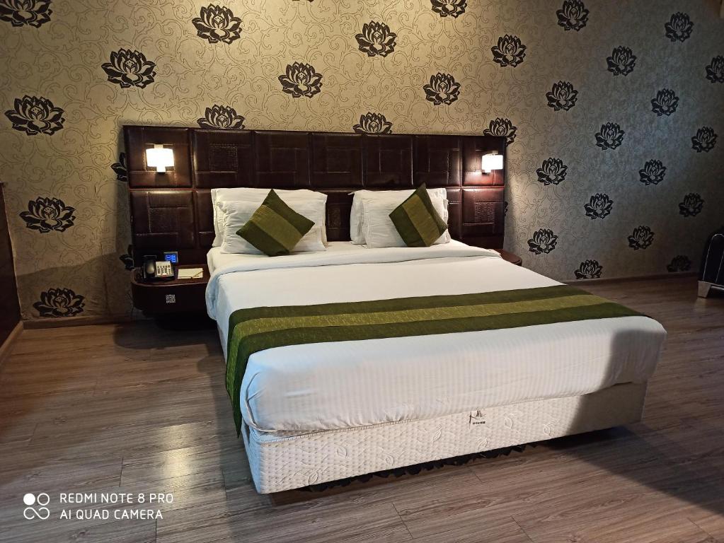 a bedroom with a large bed in a room at Hotel Patliputra Exotica in Patna