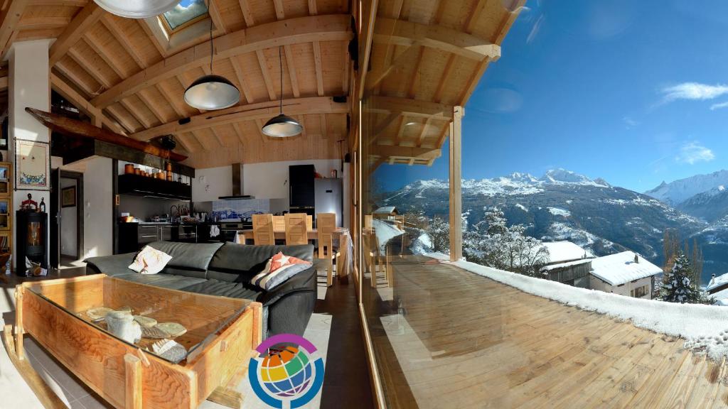 a living room with a view of a mountain at La Case à Kio in Bourg-Saint-Maurice