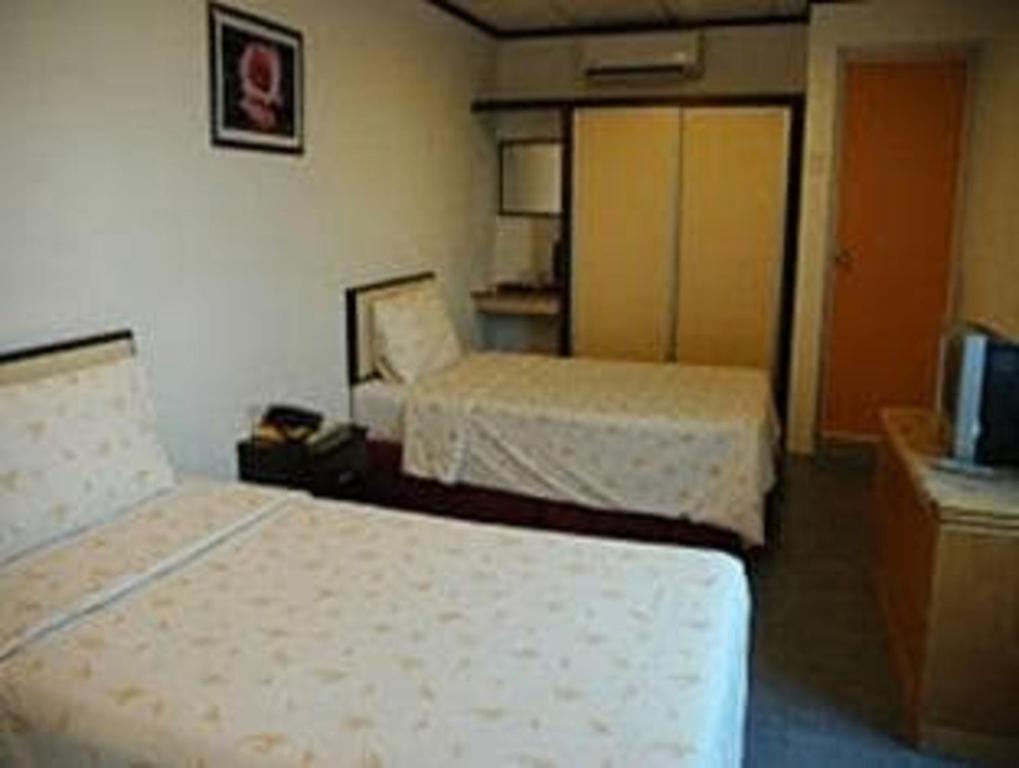 Postel nebo postele na pokoji v ubytování TS Hotel - Taman Rinting