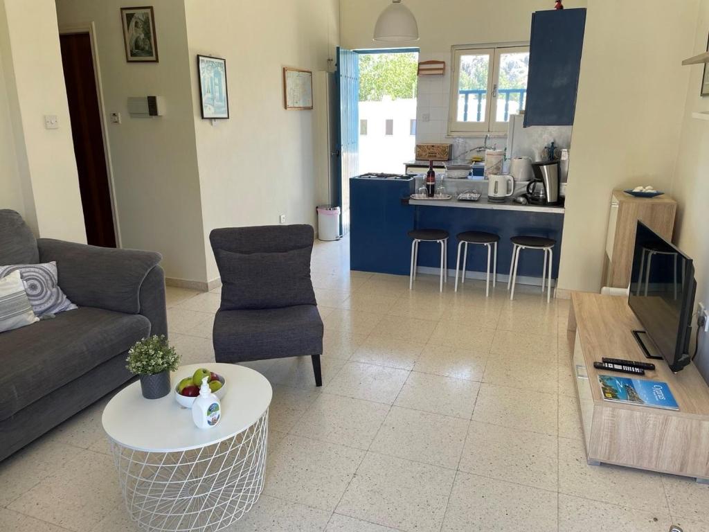 a living room with a couch and a table at Vitamin Sea Protaras in Protaras