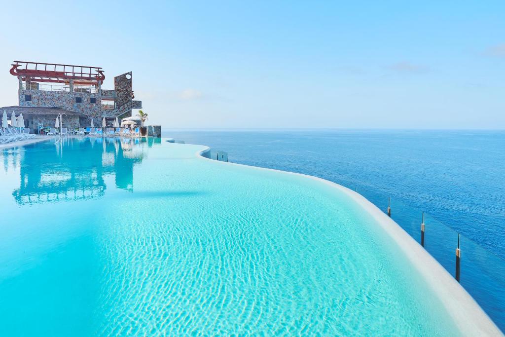 a swimming pool in the middle of the ocean at Gloria Palace Amadores Thalasso & Hotel in Puerto Rico de Gran Canaria