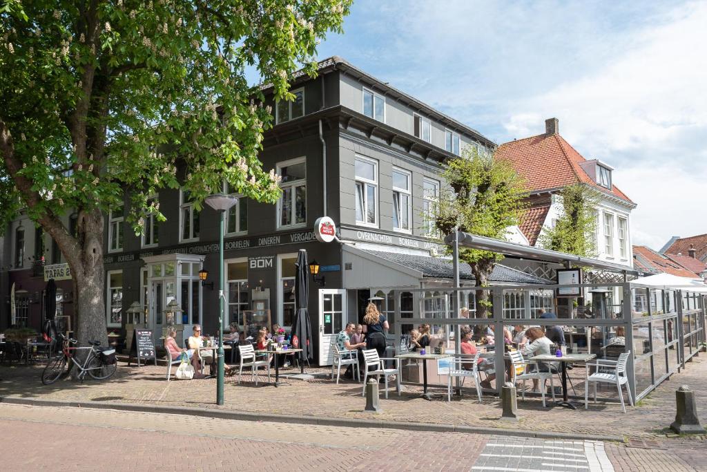 a street scene with people walking down the street at Hotel Bom in Burgh Haamstede