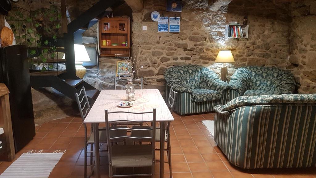 Zimmer mit 2 Sofas, einem Tisch und Stühlen in der Unterkunft A Brava in Sas de Penelas