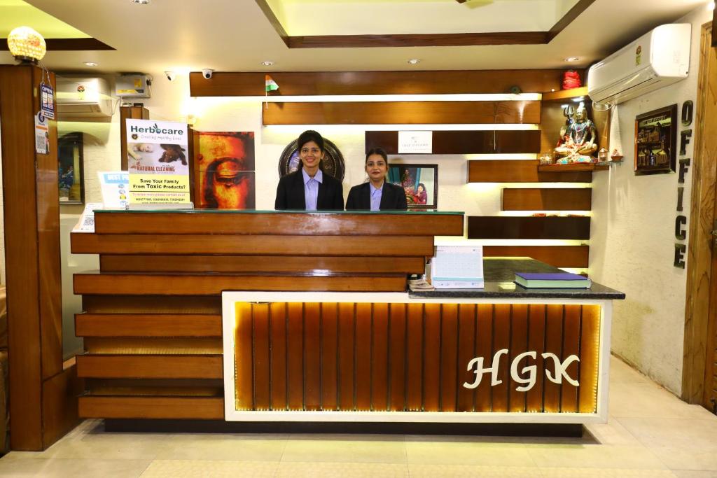 two people standing at a counter in a store at Hotel Grand Kailash,Kotdwara in Kotdwāra