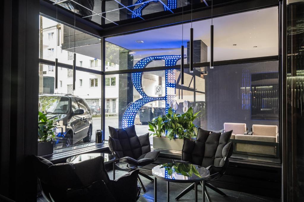 a room with chairs and a table and a window at Hotel Belmont Classic in Bonn