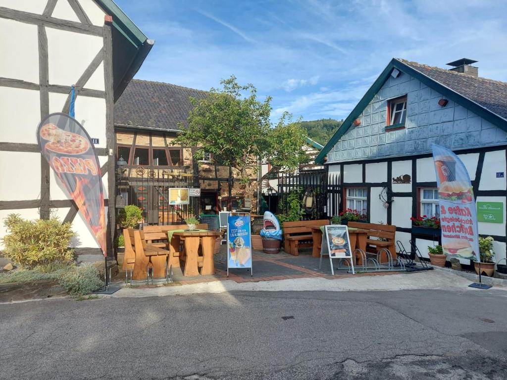 a building with tables and signs in front of it at Ferienhof Schmickerath in Simmerath