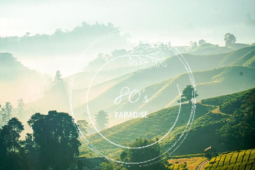 a view of a hill with a sign that reads do paradise at 80'S PARADISE in Tanah Rata