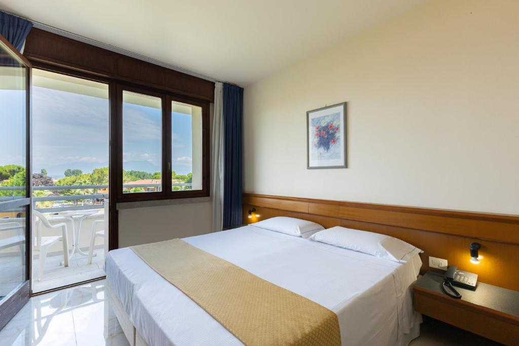 Postel nebo postele na pokoji v ubytování Hotel Du Parc