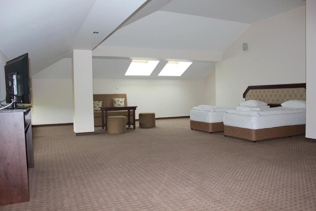 Postel nebo postele na pokoji v ubytování Hotel Podkovata