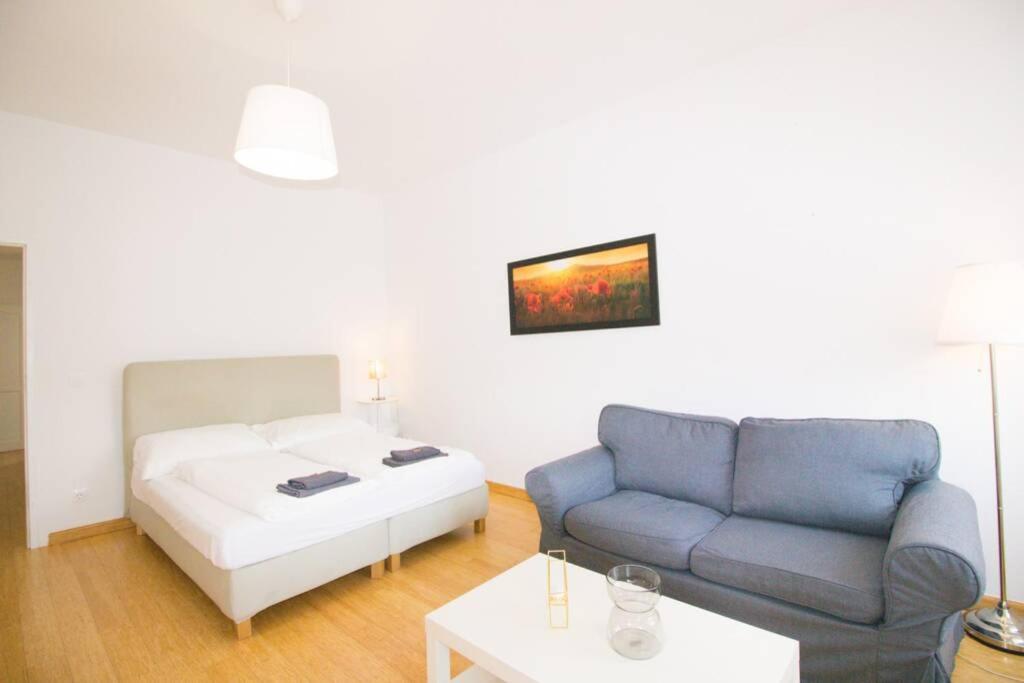 a living room with a couch and a bed at Studio-Apartment between Schoenbrunn & the City Center (26) in Vienna