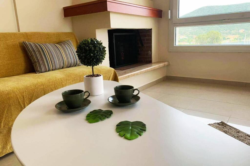 a living room with a table with two cups and a plant at Port View House-Comfy Family Apartment-Panoramic View in Néa Péramos