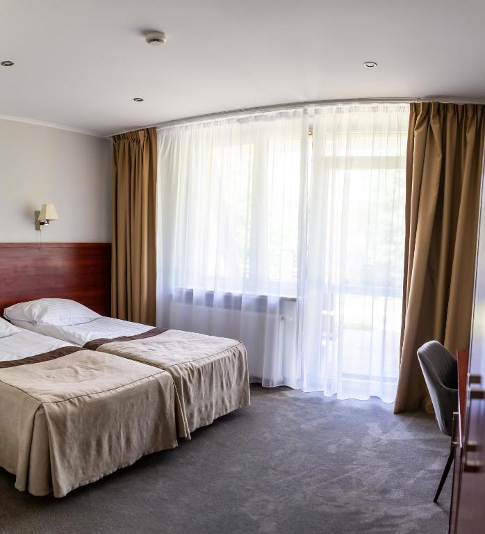 Posteľ alebo postele v izbe v ubytovaní POŁONINY Resort