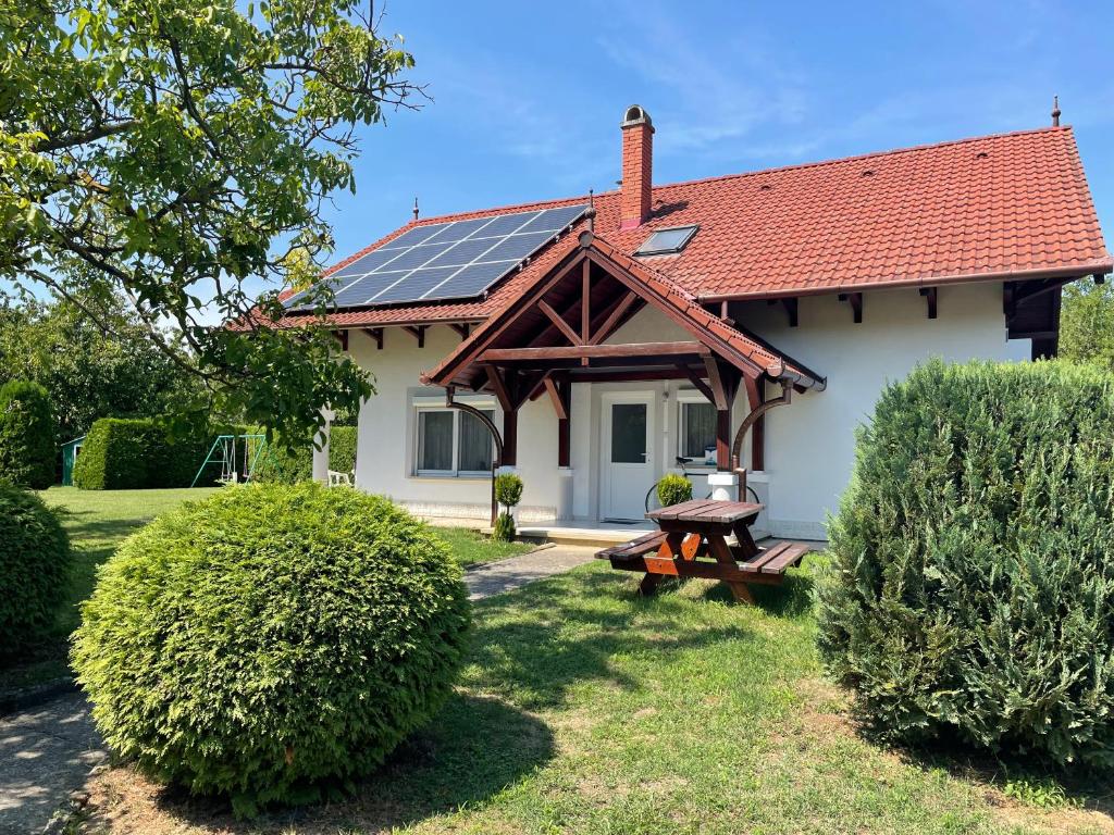 a house with a roof with solar panels on it at Frankie Holiday Apartment III. in Balatongyörök
