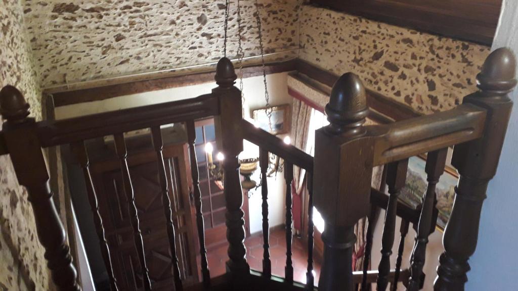 a stairway with a wooden railing and a staircase with a staircase at Gîte Yanou in Sault-de-Navailles