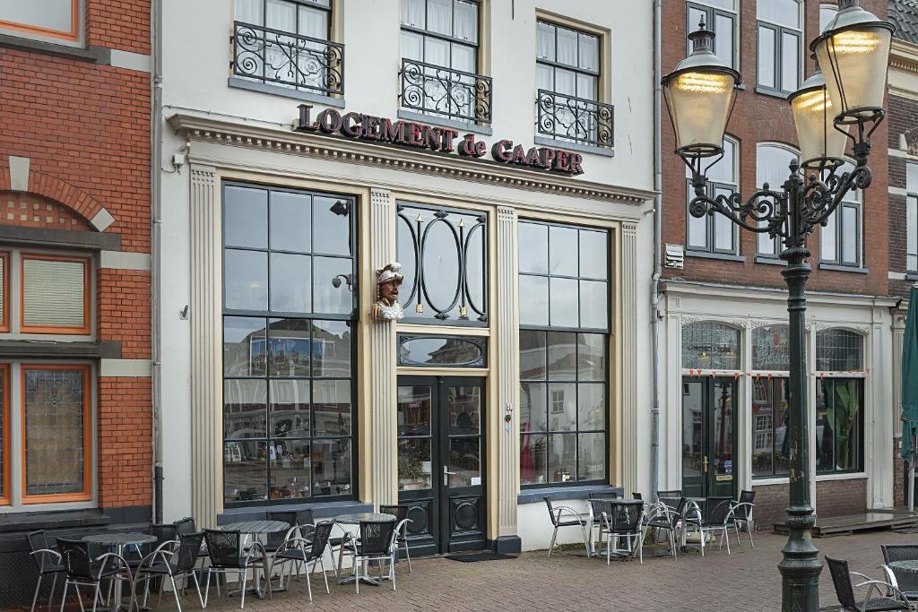 
a restaurant with a clock on the front of it at Hotel de Gaaper in Amersfoort
