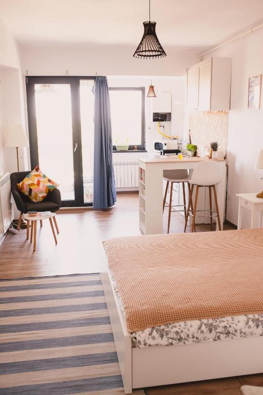 a living room with a bed and a kitchen at Retro Studio by the SEA in Eforie Nord