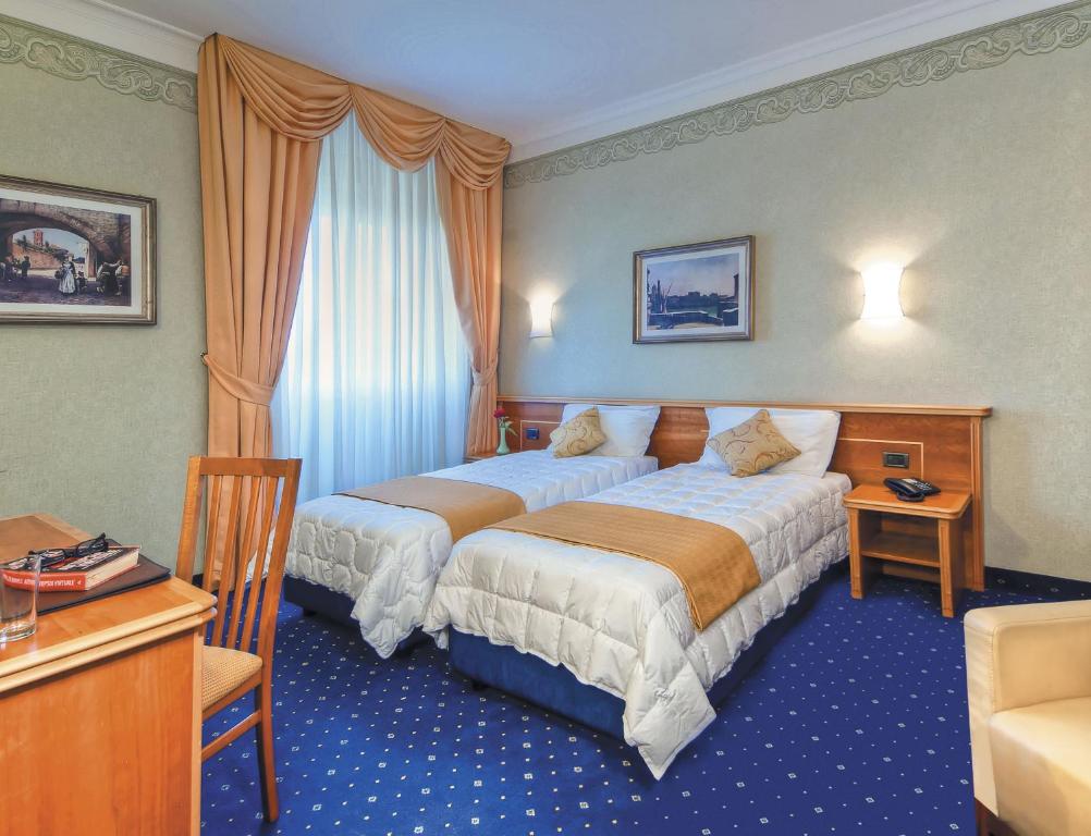 Postel nebo postele na pokoji v ubytování Ele Green Park Hotel Pamphili