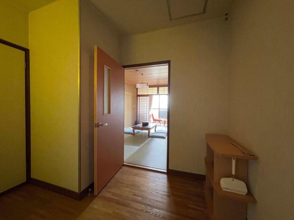 an empty room with a door and a room with a table at Iso Tokei - Vacation STAY 61892v in Kanayama