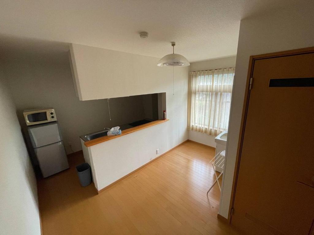 an empty room with a kitchen and a living room at Iso Tokei - Vacation STAY 61909v in Kanayama