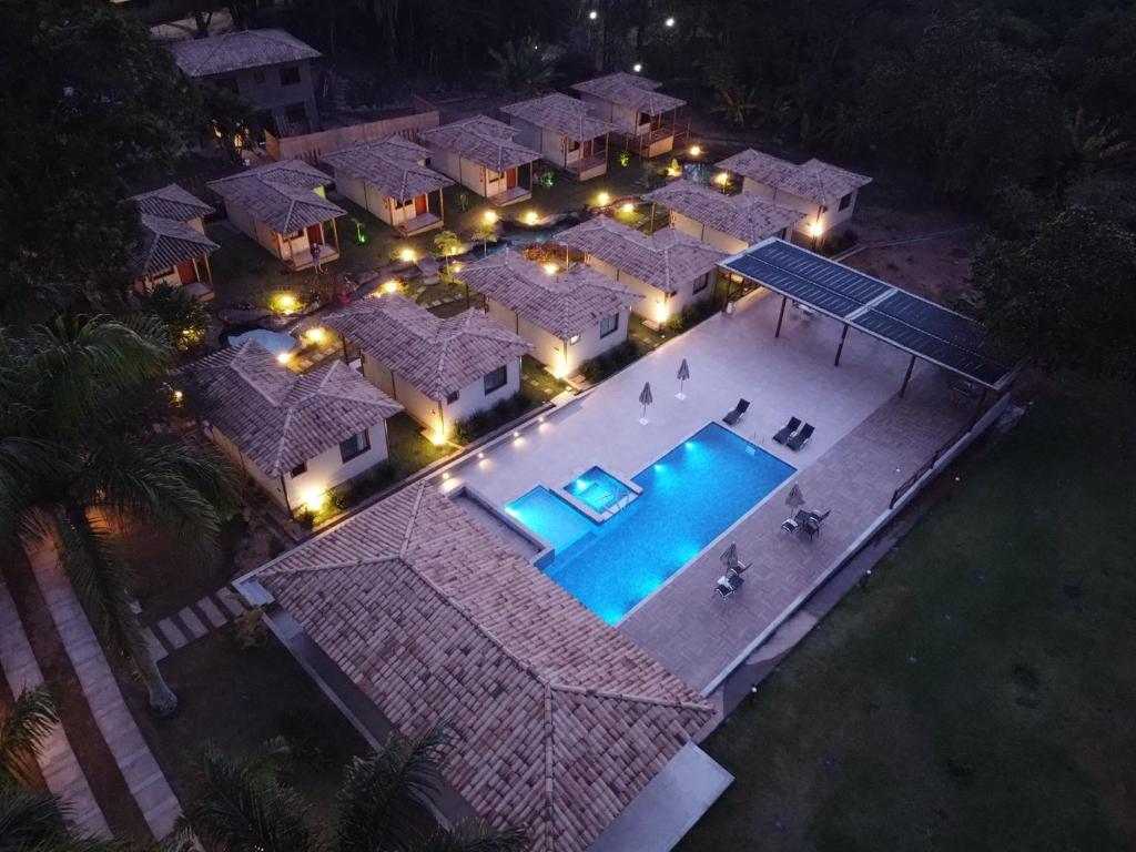 an overhead view of a house with a swimming pool at night at Pousada Villa Recanto dos Lagos in Brumadinho