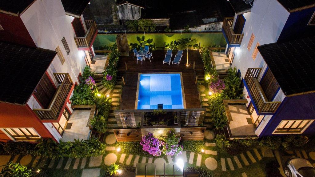 an overhead view of a courtyard at night with a swimming pool at Condomínio na Praia do Lázaro in Ubatuba