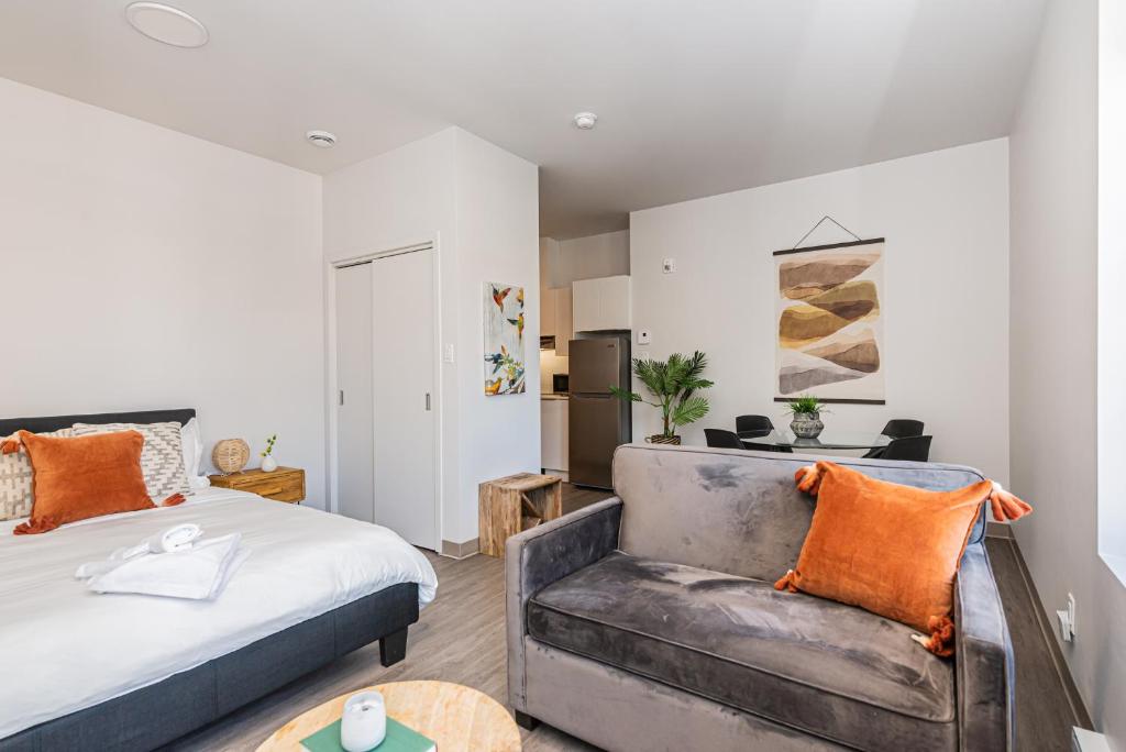 a bedroom with a bed and a chair at Wonderful New Studio close to Mount Royal By Den Stays in Montréal