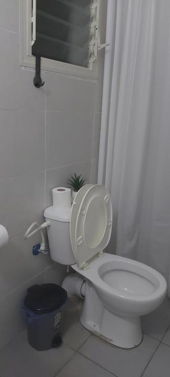 a bathroom with a toilet with a shower curtain at פרטיות וחוויה אצל יעקב וירדנה Privacy and an experience at Jacob and Yardena in Afula
