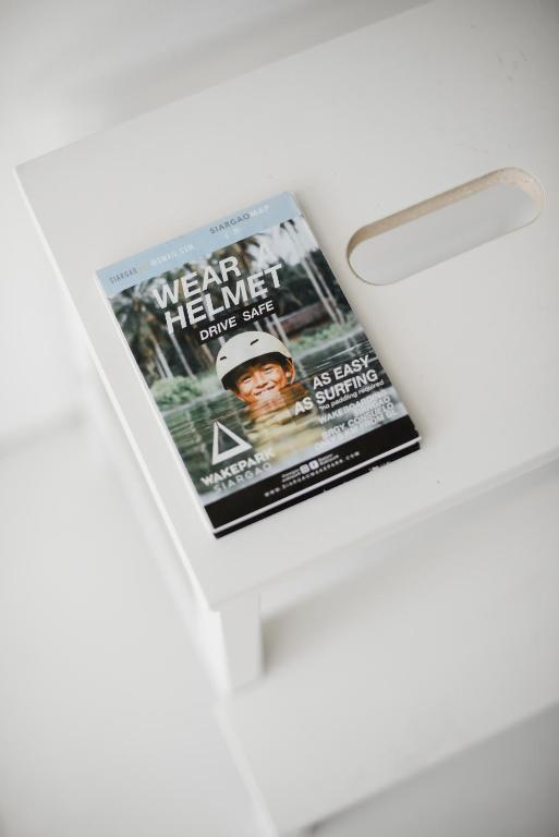 a magazine sitting on top of a white table at Suyog Life Siargao in General Luna
